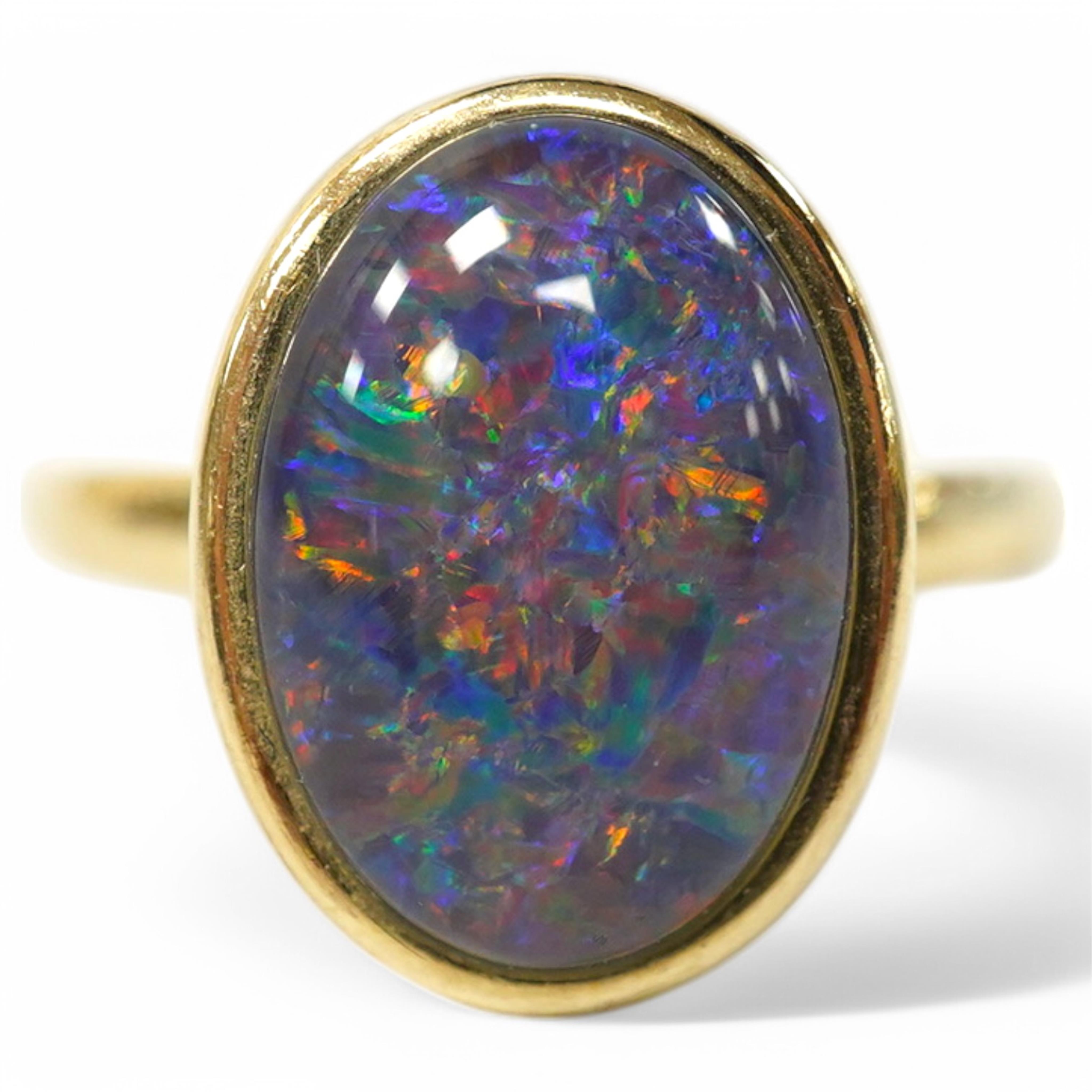 A modern 9ct gold and oval opal triplet set ring, size P/Q, gross weight 4 grams. Condition - good